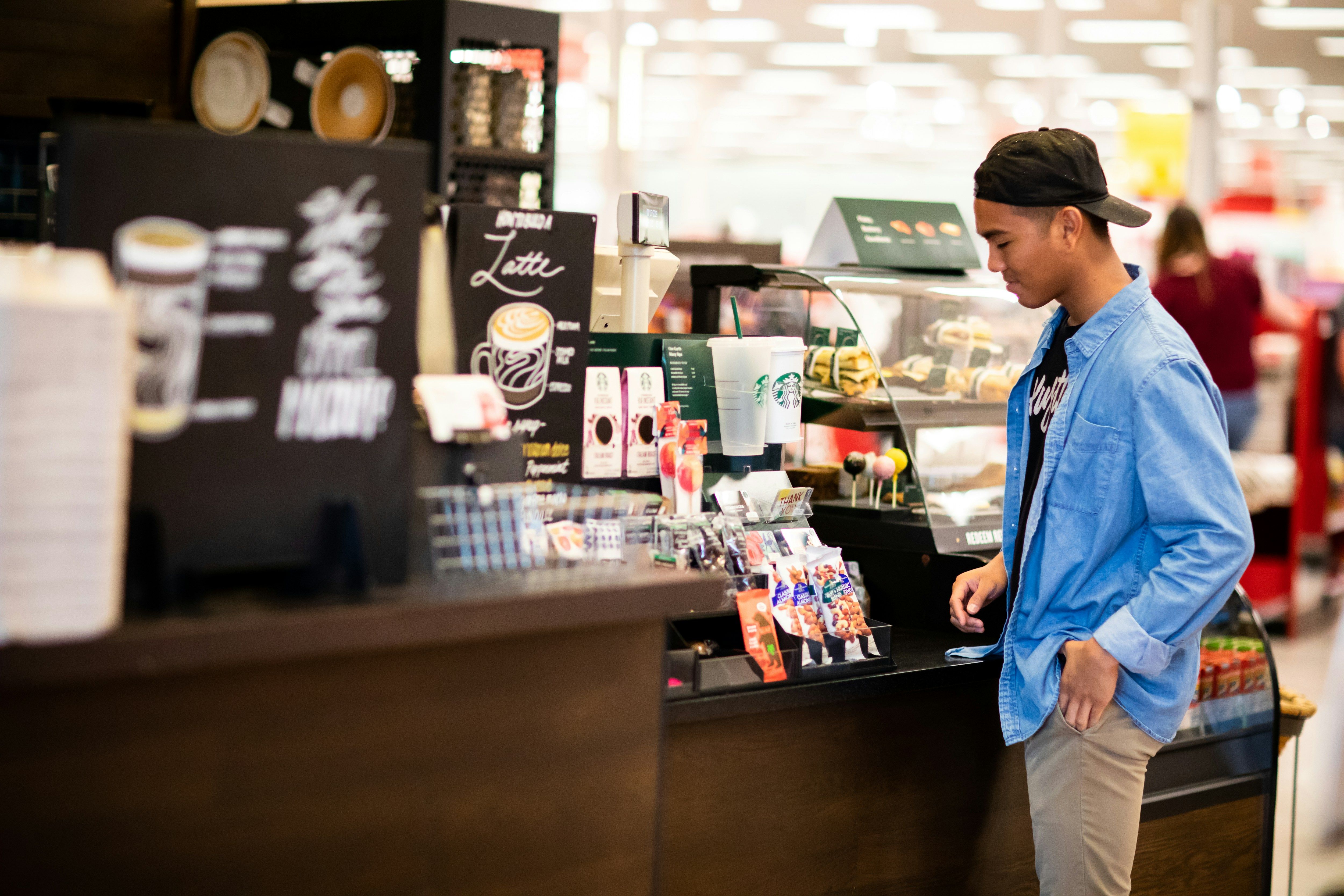 a man standing in front of a counter in a store