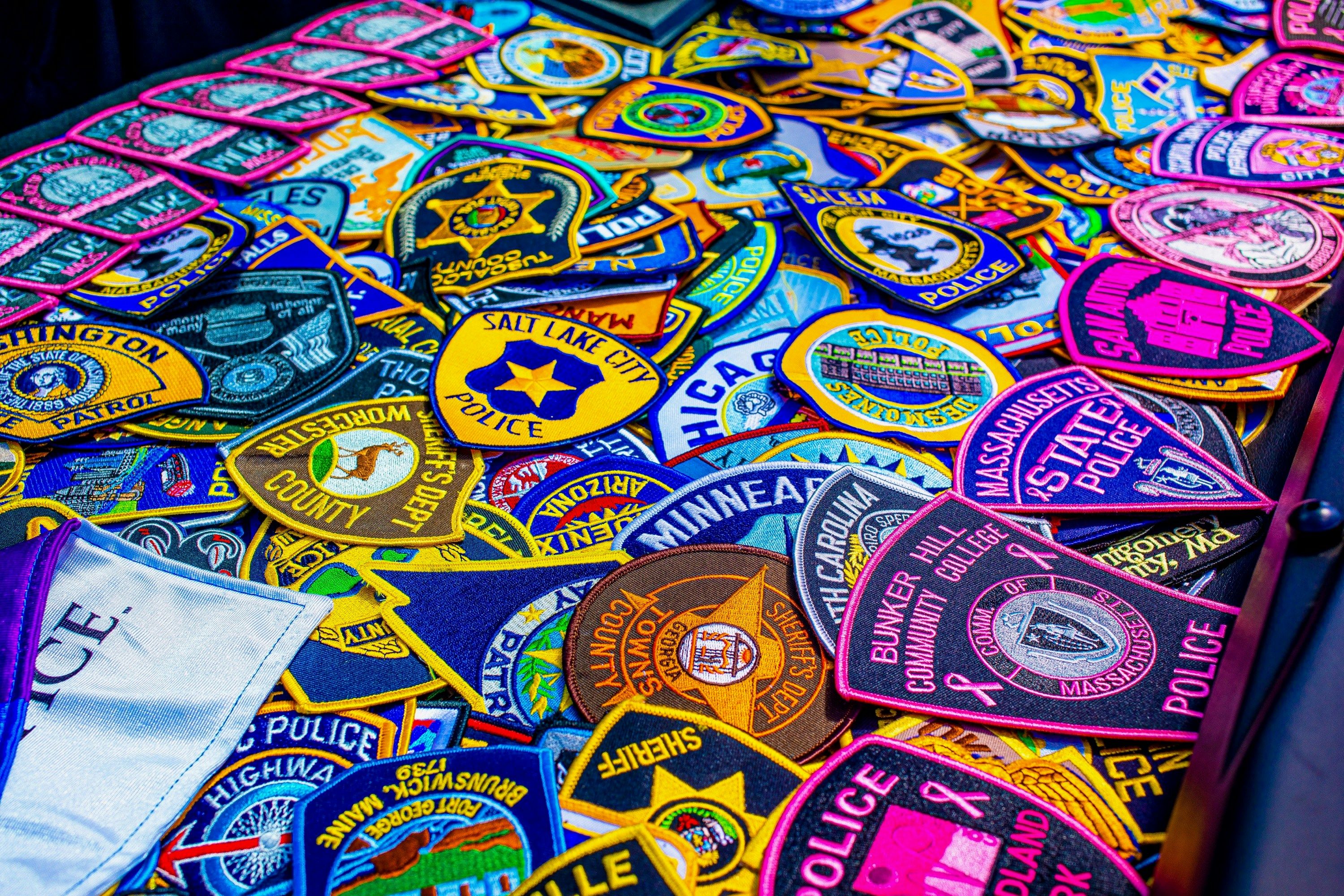 a table covered with lots of different colored patches