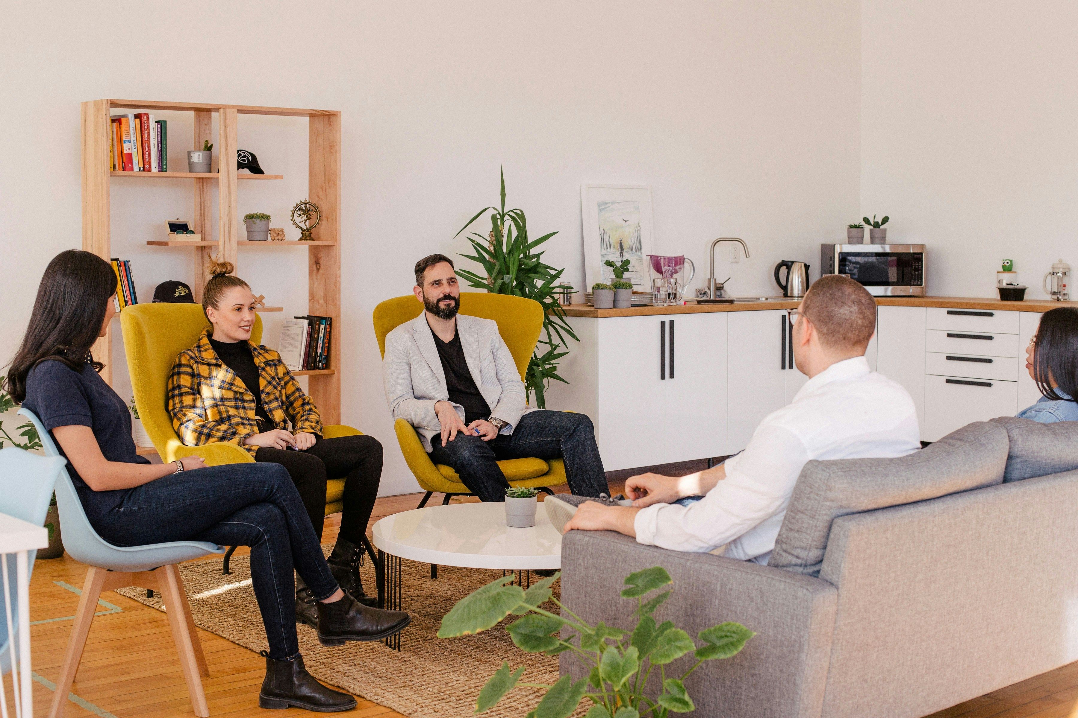 a group of people sitting around a living room together
